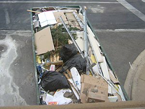 Construction dumpster behind store